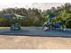 Community playground with colorful shade canopies and various play structures for entertainment at 2215 Montebell View Dr, Fuquay Varina, NC 27526