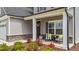 Inviting porch seating with floral accents and stone detailing, creating a welcoming entrance to the home at 2215 Montebell View Dr, Fuquay Varina, NC 27526