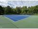 Outdoor tennis courts surrounded by mature trees offer recreational opportunities at 2215 Montebell View Dr, Fuquay Varina, NC 27526