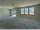 Open-concept living room featuring sliding door access and ample natural light from well-placed windows at 2410 Abbot Hall Dr, Raleigh, NC 27616