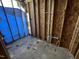 An unfinished bathroom featuring wood frame, plumbing, and a blue barrier at 249 Finley Ct, Clayton, NC 27520