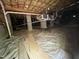Open crawlspace showing the foundation, insulated piping, and floor with a moisture barrier at 249 Finley Ct, Clayton, NC 27520