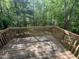 Spacious wooden deck surrounded by lush greenery, offering a serene outdoor space at 249 Finley Ct, Clayton, NC 27520