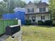 View of an attractive two-story home undergoing renovations, with a blue tarp covering part of the house at 249 Finley Ct, Clayton, NC 27520