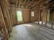 Interior view of a room under construction, showing stud framing and two windows at 249 Finley Ct, Clayton, NC 27520