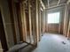 Interior view of a room under construction, showing stud framing and a window at 249 Finley Ct, Clayton, NC 27520