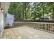 Expansive wooden back deck offering serene views of the fenced backyard, great for relaxing and enjoying the outdoors at 2611 Sawmill Rd, Raleigh, NC 27613