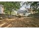 Private backyard with a wooden fence, established trees, and a well-maintained lawn, providing a serene and spacious outdoor area at 2611 Sawmill Rd, Raleigh, NC 27613