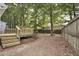 Spacious backyard featuring a wooden deck, mature trees, and a privacy fence, ideal for outdoor activities and relaxation at 2611 Sawmill Rd, Raleigh, NC 27613