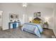 Bright bedroom with vaulted ceiling, light blue duvet, and two decorative side tables at 2611 Sawmill Rd, Raleigh, NC 27613