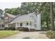Charming home featuring a welcoming front porch, a well-manicured lawn, and beautiful landscaping at 2611 Sawmill Rd, Raleigh, NC 27613