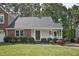 Charming single-story home featuring a welcoming front porch, lush landscaping, and a well-maintained lawn at 2611 Sawmill Rd, Raleigh, NC 27613