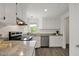 Bright kitchen featuring stainless steel appliances, granite countertops, and ample white cabinetry at 2611 Sawmill Rd, Raleigh, NC 27613