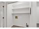 Practical laundry area featuring convenient shelving and utility connections for efficient home maintenance at 2611 Sawmill Rd, Raleigh, NC 27613