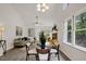Open-concept living area with vaulted ceilings, large windows, and ample natural light at 2611 Sawmill Rd, Raleigh, NC 27613