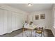 Bright home office with sleek desk, artwork, and ample closet space, creating a perfect work-from-home environment at 2611 Sawmill Rd, Raleigh, NC 27613
