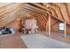 Spacious unfinished attic with exposed wood beams, insulation and plywood flooring at 2821 Penfold Ln, Wake Forest, NC 27587
