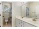 Bathroom featuring a double sink vanity, toilet and shower with decorative shower curtain and window for natural light at 2821 Penfold Ln, Wake Forest, NC 27587