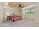 Bedroom with a large window, ceiling fan and tray ceiling creating a luxurious and bright space at 2821 Penfold Ln, Wake Forest, NC 27587