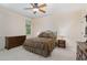 Comfortable bedroom featuring a ceiling fan, bedside tables and lamps, and a large window with natural light at 2821 Penfold Ln, Wake Forest, NC 27587