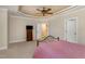 Spacious bedroom featuring tray ceiling, large window and ceiling fan at 2821 Penfold Ln, Wake Forest, NC 27587