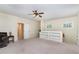 Expansive bonus room with ceiling fan, natural light, and built in shelves perfect for storage or decor at 2821 Penfold Ln, Wake Forest, NC 27587