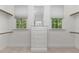 Walk-in closet with windows, built in drawers, and rods for ample storage space at 2821 Penfold Ln, Wake Forest, NC 27587