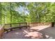 Wooden deck with built-in benches surrounded by mature trees offering a private outdoor space at 2821 Penfold Ln, Wake Forest, NC 27587