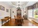 Traditional dining room with hardwood floors, a wooden table, and a large window at 2821 Penfold Ln, Wake Forest, NC 27587