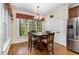 Cozy dining area with hardwood floors and stainless steel refrigerator at 2821 Penfold Ln, Wake Forest, NC 27587