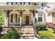 Inviting home with a covered front porch, stone steps, wood columns, and beautifully landscaped front yard at 2821 Penfold Ln, Wake Forest, NC 27587