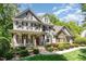 Inviting home with a covered front porch, stone steps, wood columns, and beautifully landscaped front yard at 2821 Penfold Ln, Wake Forest, NC 27587