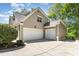 Spacious three-car garage with a concrete driveway and manicured landscaping at 2821 Penfold Ln, Wake Forest, NC 27587