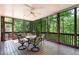 Relaxing screened porch with ceiling fan, seating, and serene wooded views at 2821 Penfold Ln, Wake Forest, NC 27587