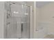 Bathroom featuring a clear standing shower and a white soaking tub at 3212 Imperial Oaks Dr, Raleigh, NC 27614