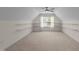 Bonus room featuring neutral paint, vaulted ceilings, shelving and bright lighting at 3212 Imperial Oaks Dr, Raleigh, NC 27614