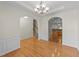 Inviting dining area with hardwood floors, arched doorways, and views of kitchen and staircase at 3212 Imperial Oaks Dr, Raleigh, NC 27614