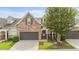 Charming two-story home featuring a stone facade, well-maintained landscaping, and a two-car garage at 3212 Imperial Oaks Dr, Raleigh, NC 27614