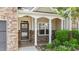 Welcoming front porch with stone accents, white pillars, and manicured greenery at 3212 at 3212 Imperial Oaks Dr, Raleigh, NC 27614