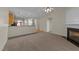 Inviting living room features plush carpeting, a cozy fireplace, and seamless access to the kitchen area at 3212 Imperial Oaks Dr, Raleigh, NC 27614