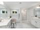 Bright bathroom featuring double sinks, a shower, and a separate tub with light grey tile at 3621 Bailey Lake Dr, Fuquay Varina, NC 27526