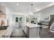 Open-concept kitchen with white cabinets, stainless steel appliances, and a view of the living room and dining area at 3621 Bailey Lake Dr, Fuquay Varina, NC 27526