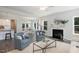 Bright living room with a fireplace, comfortable seating, and views of the backyard at 3621 Bailey Lake Dr, Fuquay Varina, NC 27526