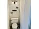 Toilet in a bathroom with black shelves on the wall and gray flooring at 3648 Sleepy Hollow, Wake Forest, NC 27587