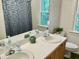 Bathroom with dual sinks, white countertops, and a decorative shower curtain at 3648 Sleepy Hollow, Wake Forest, NC 27587