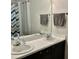 Bathroom with dual sinks, white countertops, and decorative chevron shower curtain at 3648 Sleepy Hollow, Wake Forest, NC 27587