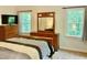 Bright bedroom featuring two windows, a dresser, and a comfortable bed at 3648 Sleepy Hollow, Wake Forest, NC 27587