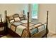 Comfortable bedroom featuring a four-poster bed and a bright window view at 3648 Sleepy Hollow, Wake Forest, NC 27587