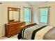 Sunlit bedroom with two windows, a dresser, and cozy bed setting at 3648 Sleepy Hollow, Wake Forest, NC 27587
