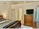Comfortable bedroom with modern dresser and TV, plus an open doorway at 3648 Sleepy Hollow, Wake Forest, NC 27587